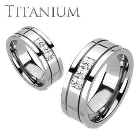 Oxygen - A trio of square cut cubic zirconia grooved band titanium his and hers ring